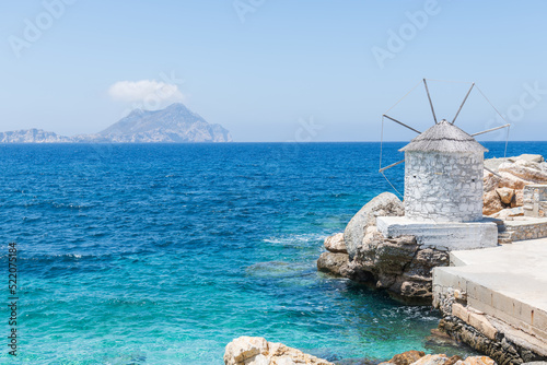 Traditional white windmill in the port of Aegiali on Amorgos island in Greece.