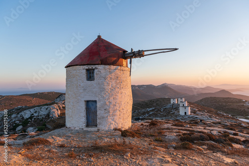 Traditional windmill of Chora, on Amorgos island in Greece with more windmills in the background.