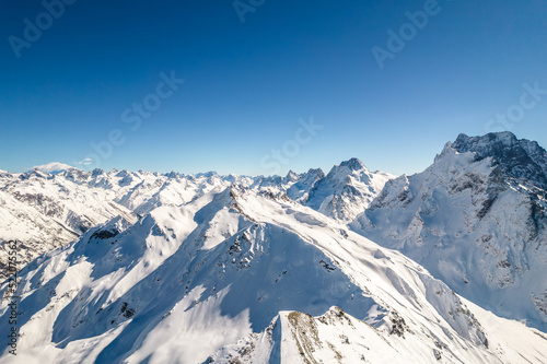 Mountain peak covered with snow against a blue sky 