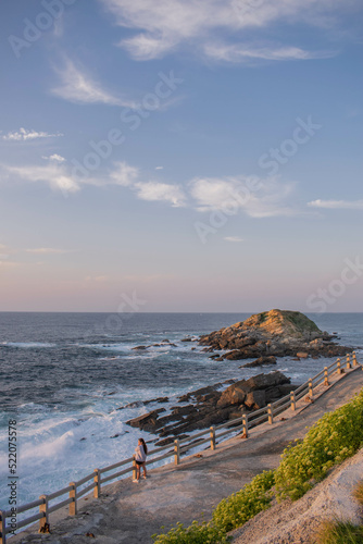 Background of a sea breaking on a cliff at sunset