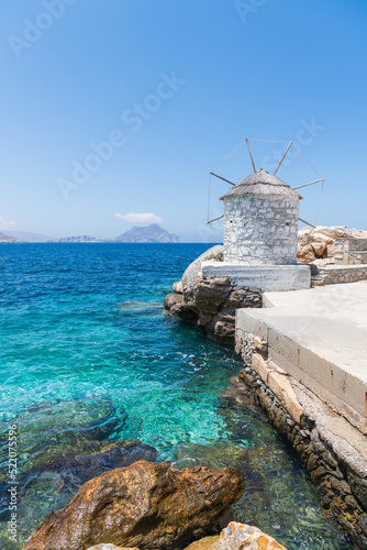 Traditional white windmill in the port of Aegiali on Amorgos island in Greece.