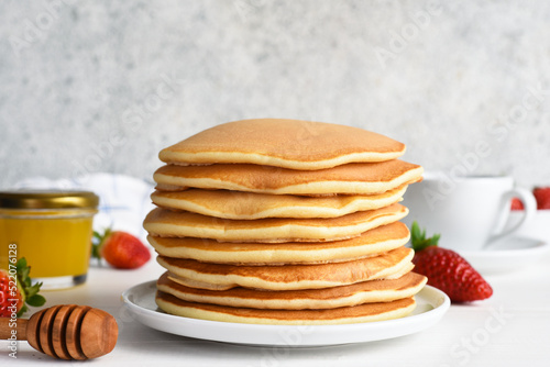 Stack of honey pancakes, homemade strawberry pancakes for breakfast