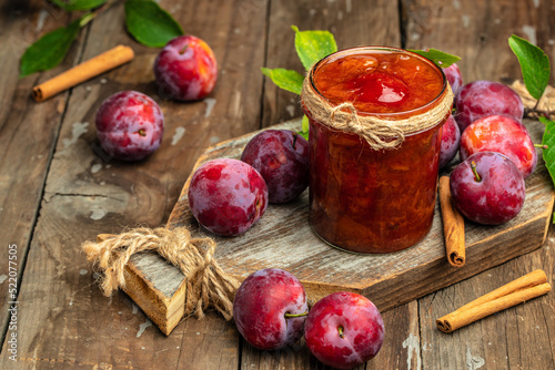 plum jam nd fresh plums on a wooden background. banner, menu, recipe place for text photo