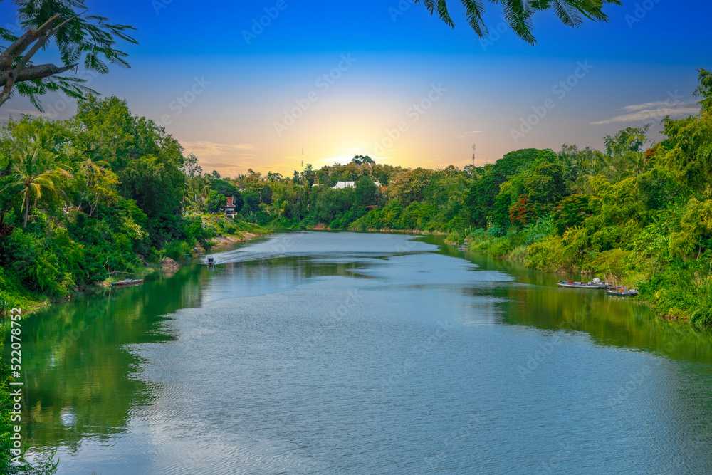 Fototapeta premium Luang Prabang Laos, beautiful river surrounded by lush green mountains and lovely historical houses
