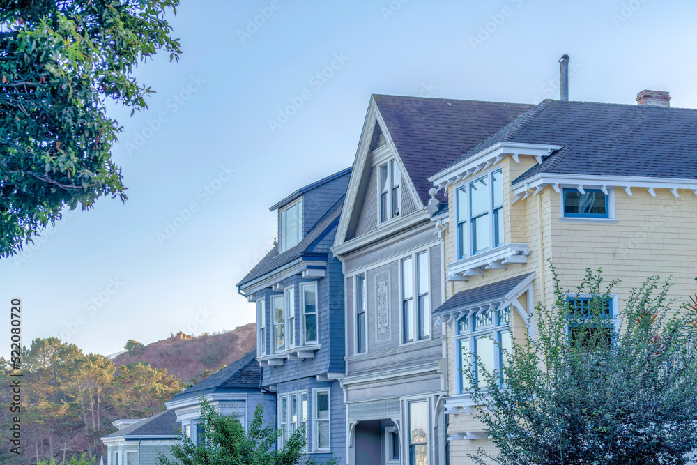 Neighborhood in San Francisco, CA with row of houses Neighborhood in San Francisco, CA with row of houses