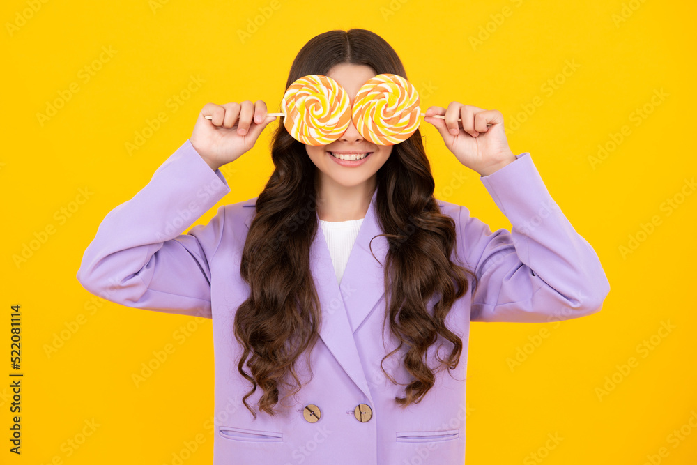 Teen girl hold lollipop caramel on yellow background, candy shop. Teenager with sweets suckers. Happy teenager, positive and smiling emotions of teen girl. Teen girl hold lollipop caramel on yellow background, candy shop. Teenager with sweets suckers. Happy teenager, positive and smiling emotions of teen girl.