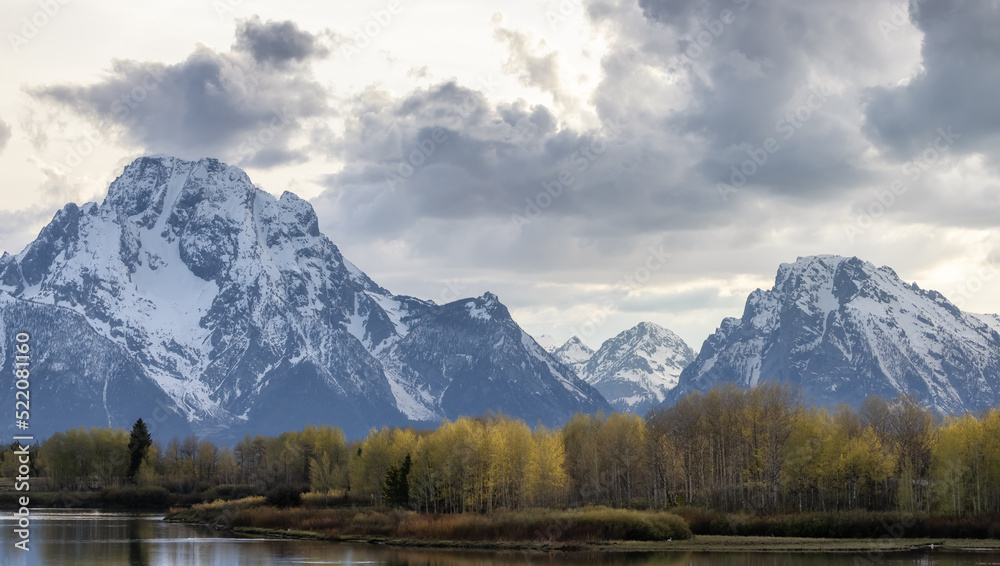 Snow Covered Mountains in American Landscape. Spring Season. Grand Teton National Park. Sunset Sky. Wyoming, United States. Nature Background.