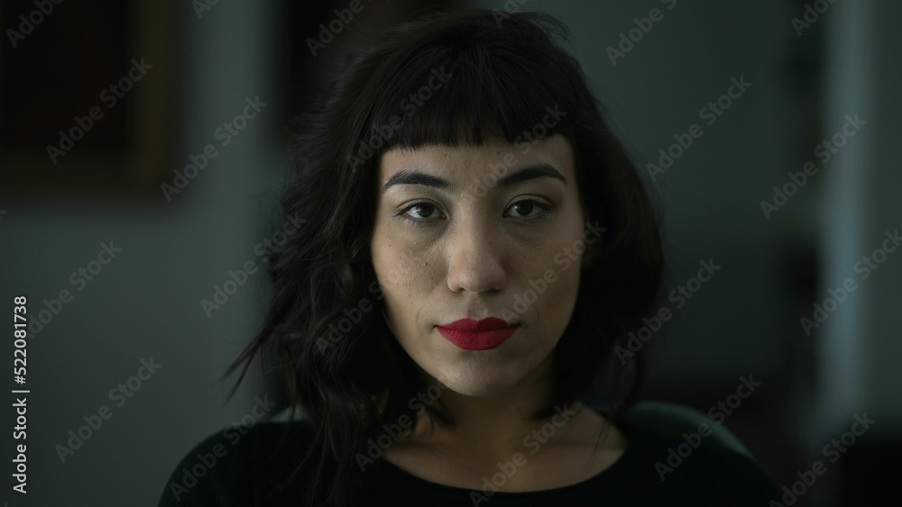 Portrait of a latin hispanic woman closeup face looking at camera with serious expression