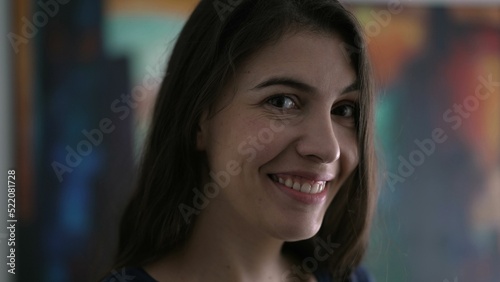 Portrait of person smiling at camera. Closeup happy woman face in 30s © Marco