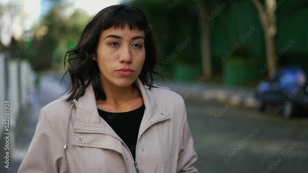 One pensive hispanic young woman walking outside in street. Confident girl walks forward One pensive hispanic young woman walking outside in street. Confident girl walks forward