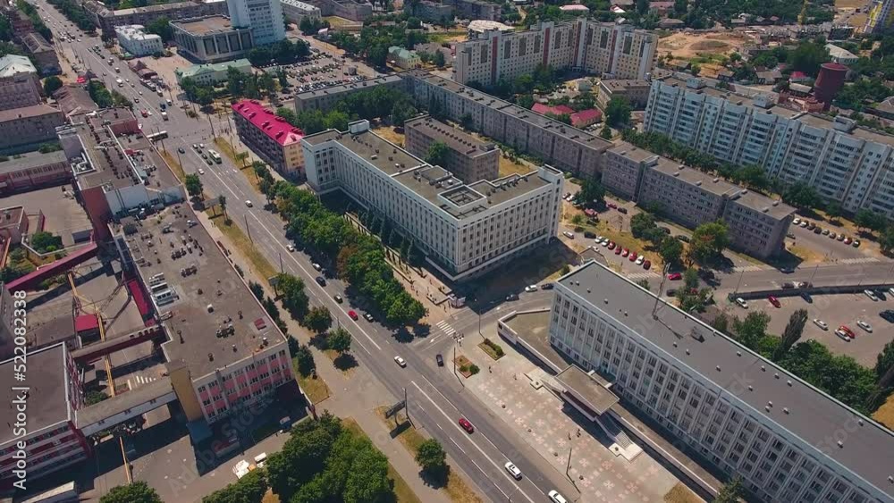 Drone flight over cityscape. Aerial view city car traffic, modern high-rise buildings, roofs Drone flight over cityscape. Aerial view city car traffic, modern high-rise buildings, roofs