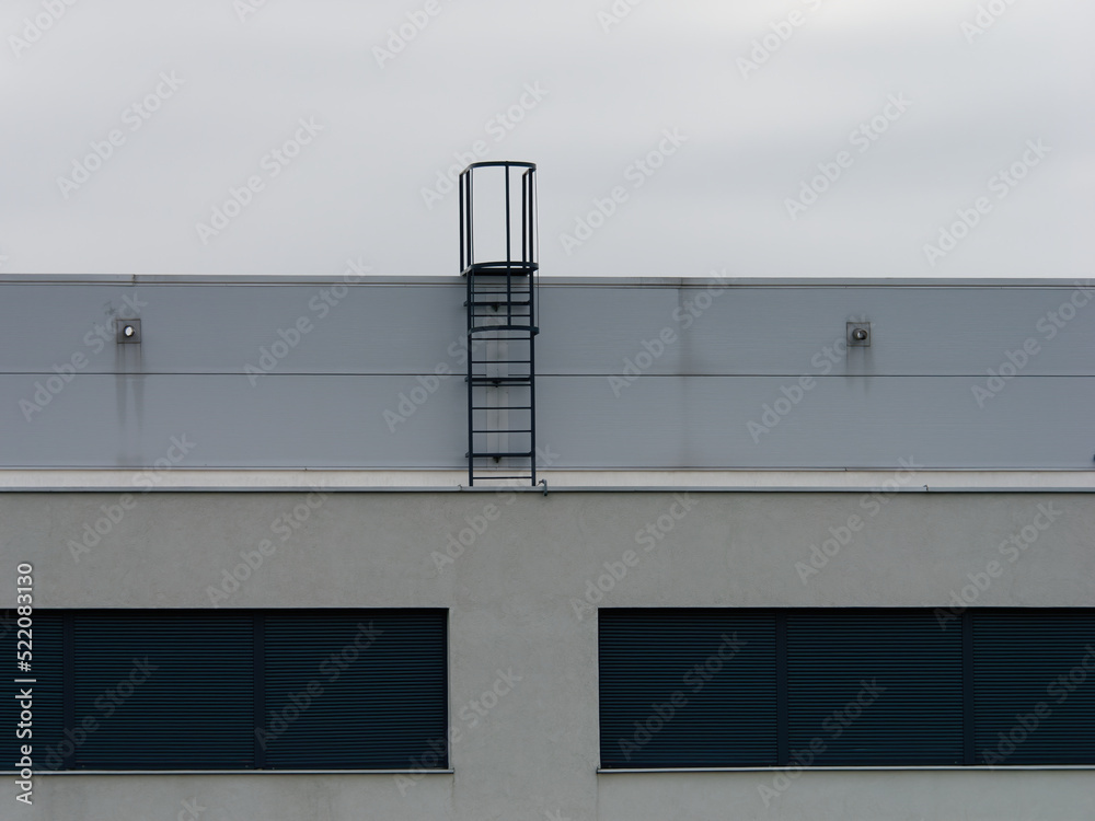 The staircase on the top of a rooftop of a modern building with a  bright sky in the background