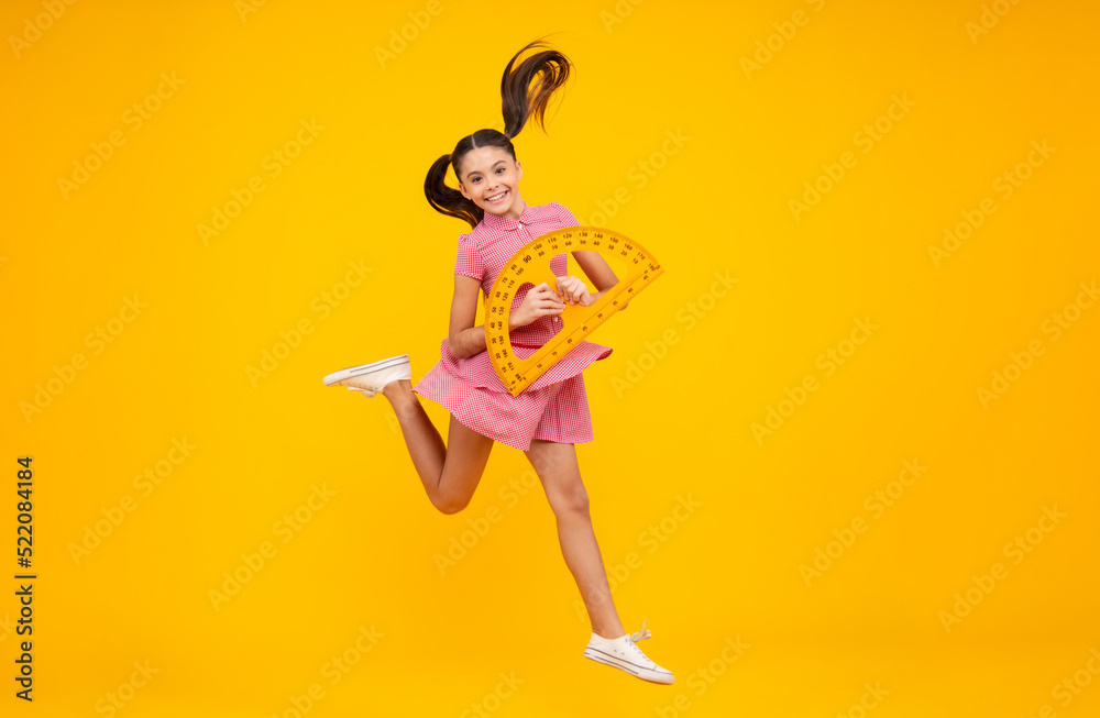 School supplies. Teenager school girl on yellow background. Crazy jump, jumping kids.