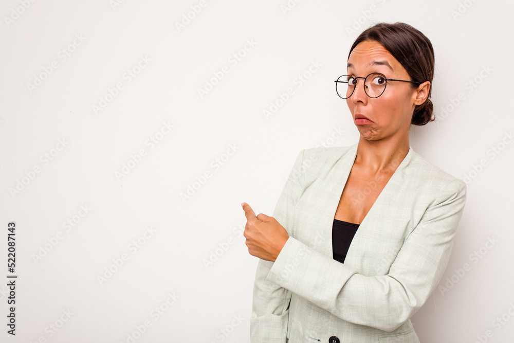 Young hispanic woman isolated on white background smiling and pointing aside, showing something at blank space. Young hispanic woman isolated on white background smiling and pointing aside, showing something at blank space.