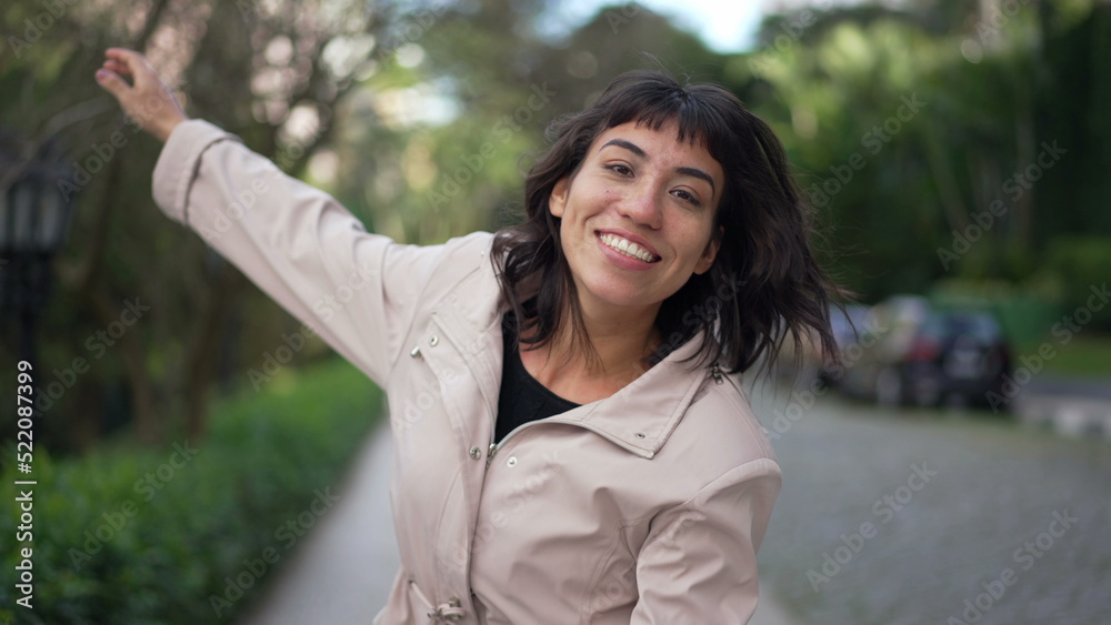 Carefree woman jumping with joy enjoying life. Female person celebrating success walking outside Carefree woman jumping with joy enjoying life. Female person celebrating success walking outside