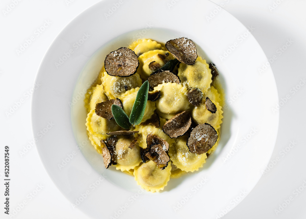 Italian ravioli with butter, parmesan cheese and truffle on the white table