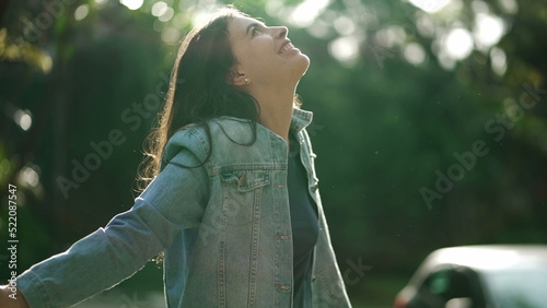 Bild auf Leinwand Carefree happy woman arms raised outside looking at sky feeling grateful