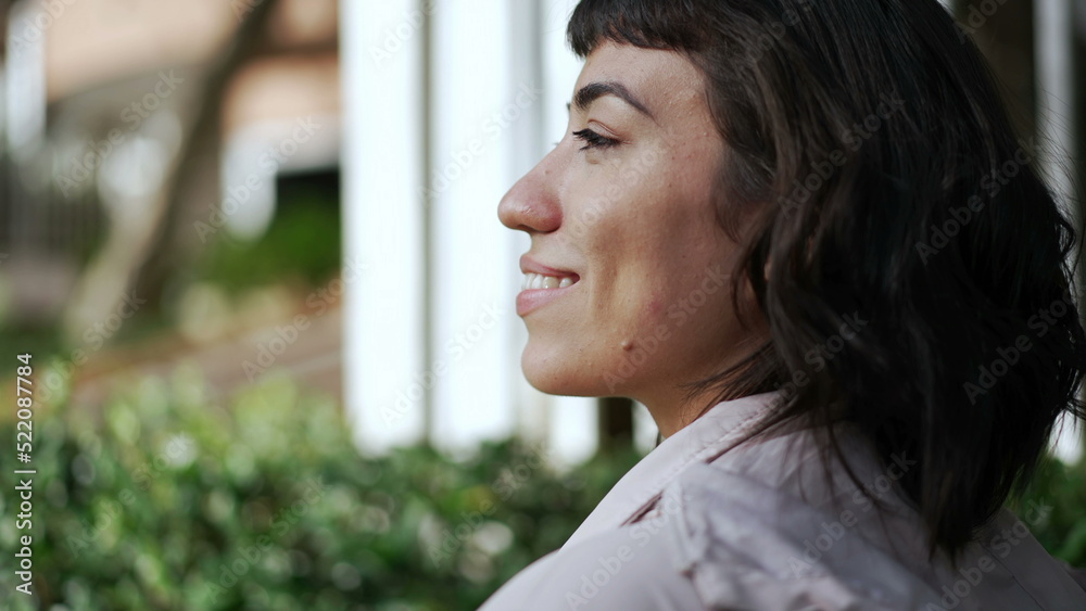 Back of a latin hispanic girl walking in street. Young woman walks forward in sidewalk Back of a latin hispanic girl walking in street. Young woman walks forward in sidewalk