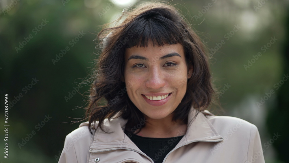 A hispanic woman with indigenous traits smiling at camera. Portrait face closeup of South American person A hispanic woman with indigenous traits smiling at camera. Portrait face closeup of South American person