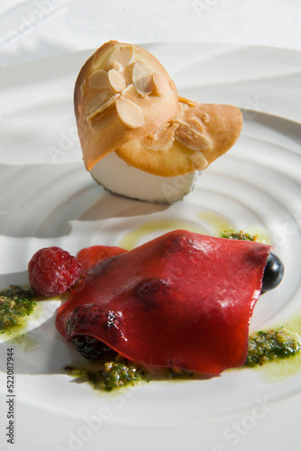 Goats cheese topped with nutty biscuit, raspberries with gelatinesed rasberry jus, and basil pesto.
