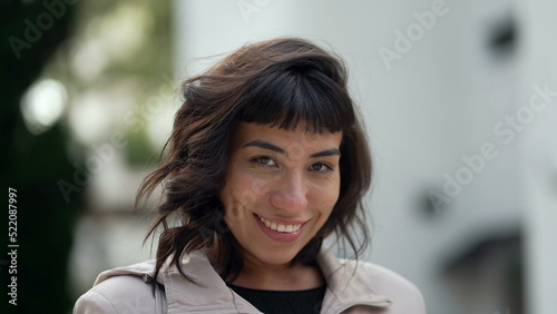 A hispanic woman with indigenous traits smiling at camera. Portrait face closeup of South American person