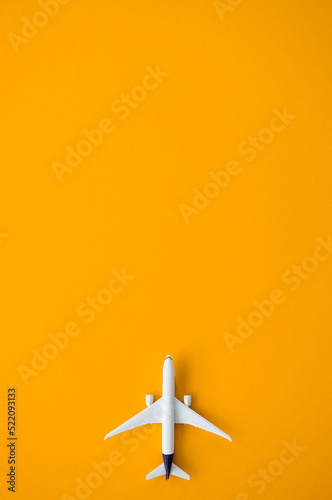 Flat lay design of travel concept with plane on yellow background