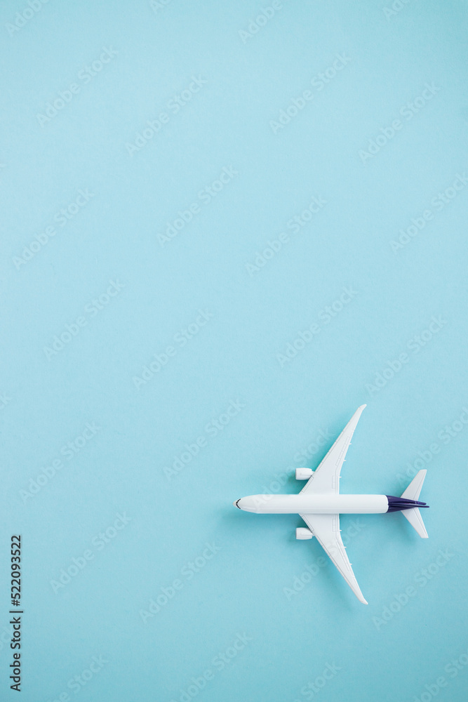 Travel concept on blue background with copy space. Airplane toy on blue color background.