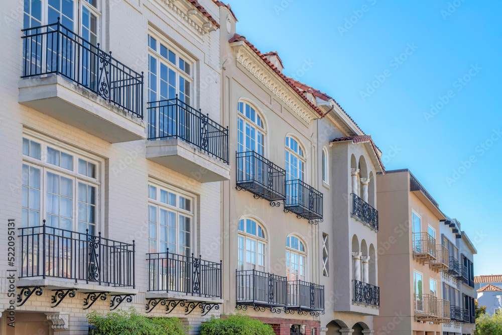 Obraz premium Row of mediterranean houses with wrought iron railings on its window balconies in San Francisco, CA