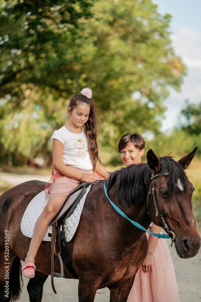 Walk mother with daughter and horse in the summer in the forest. Walk mother with daughter and horse in the summer in the forest.