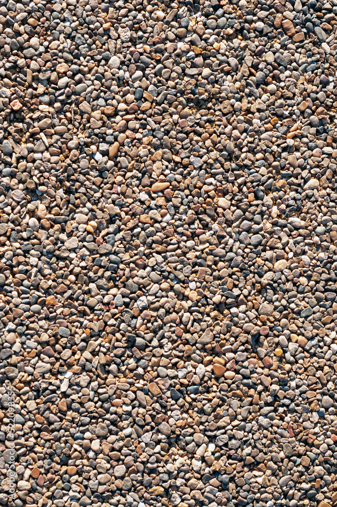 background, texture of small stones glued together to create a pedestrian zone or bike paths, vertical shot. background, texture of small stones glued together to create a pedestrian zone or bike paths, vertical shot.