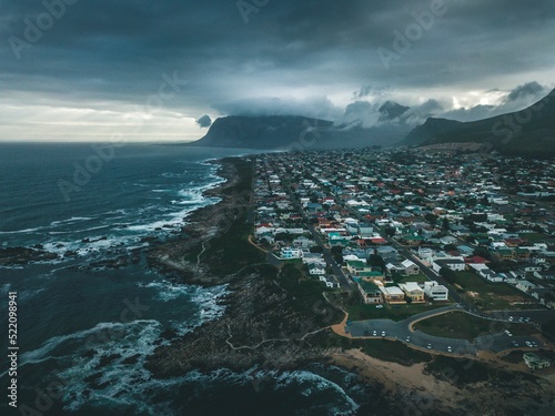 Aerial dramatic shot of a gray cloudscape over the Kleinmond beach photo