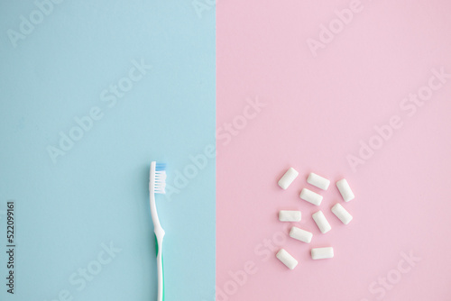 white chewing gum and brush on color background