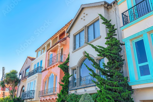 Row of mediterranean three-storey houses with trees outdoors in San Francisco, California