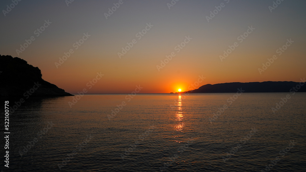 Naklejka premium sunrise in Katigiorgis on a beautiful summer morning.