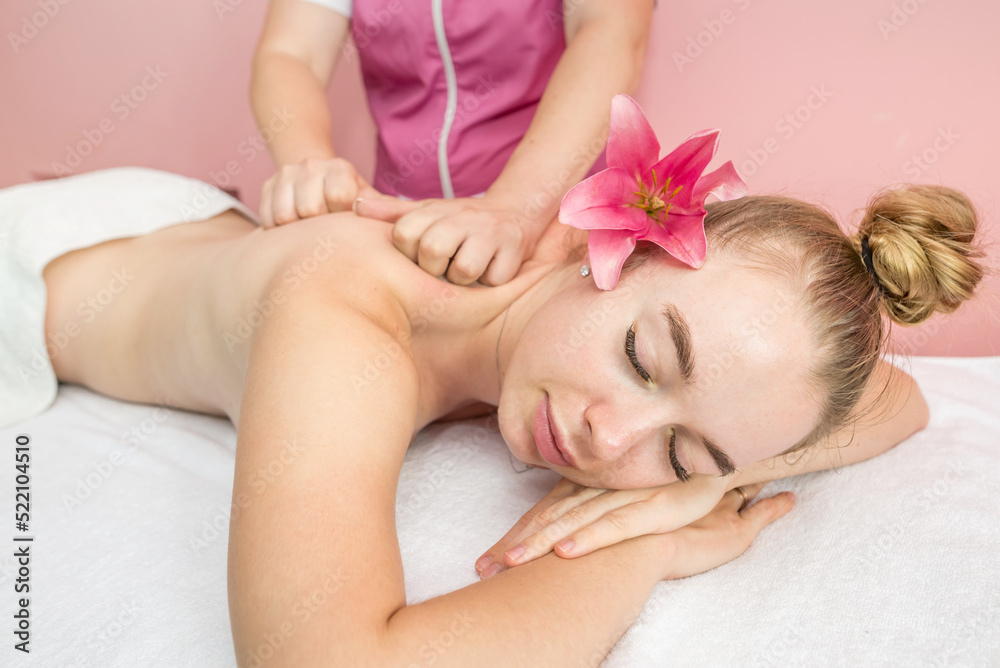 Young beautiful woman getting relaxing back and body massage Young beautiful woman getting relaxing back and body massage