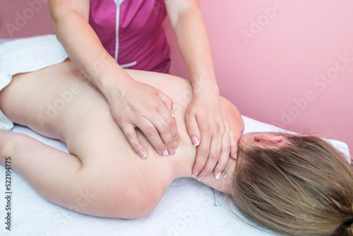 woman relaxing in the spa. The girl enjoys a back massage.