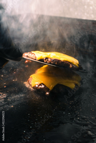 chef stacking hamburguers whit cheese photo