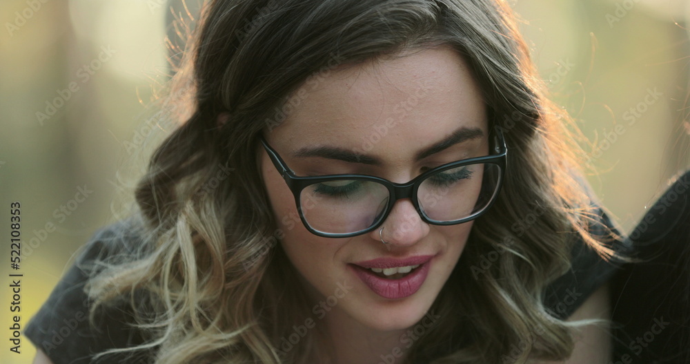 Portrait of blonde hispanic girl wearing glasses studying outside reading Portrait of blonde hispanic girl wearing glasses studying outside reading