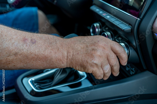 man adjusting the car's air-conditioning controls. © DoloresGiraldez