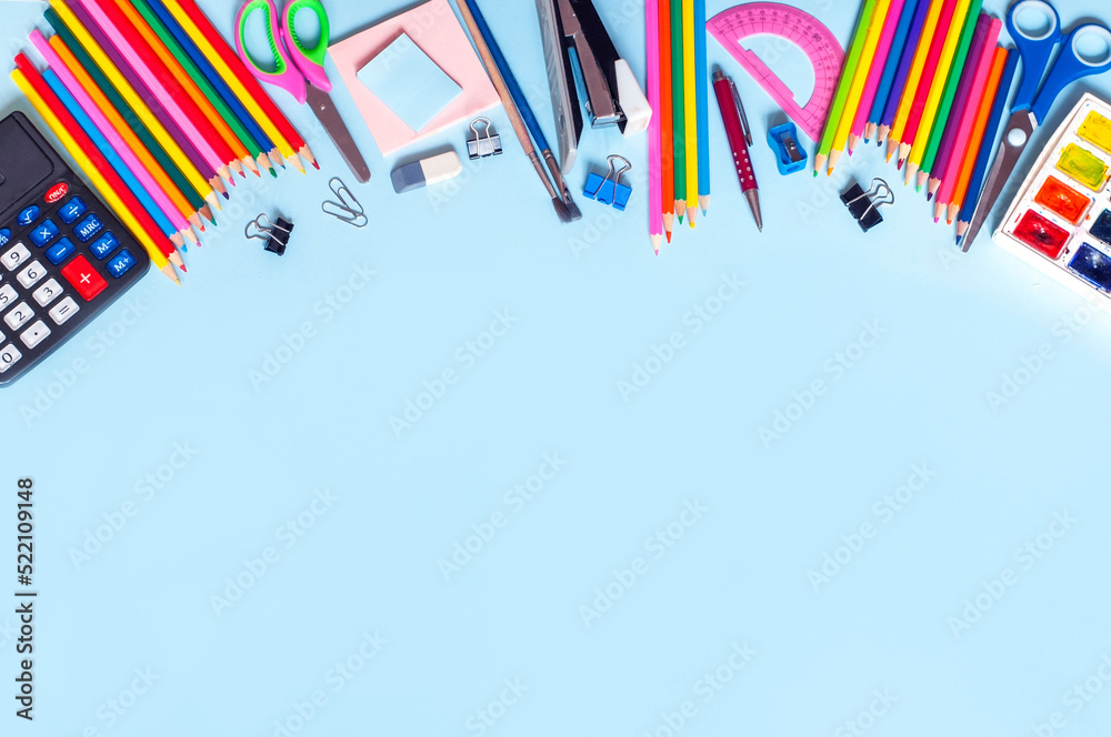 Fototapeta premium different school supplies on a blue background, back to school. High quality photo