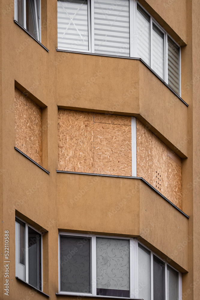 Wooden boards instead of windows. Consequences of the fall of the rocket. Ruined house. Russia's military aggression. War in Ukraine. Attack on civilians. A war-damaged house of Ukrainian civilians.