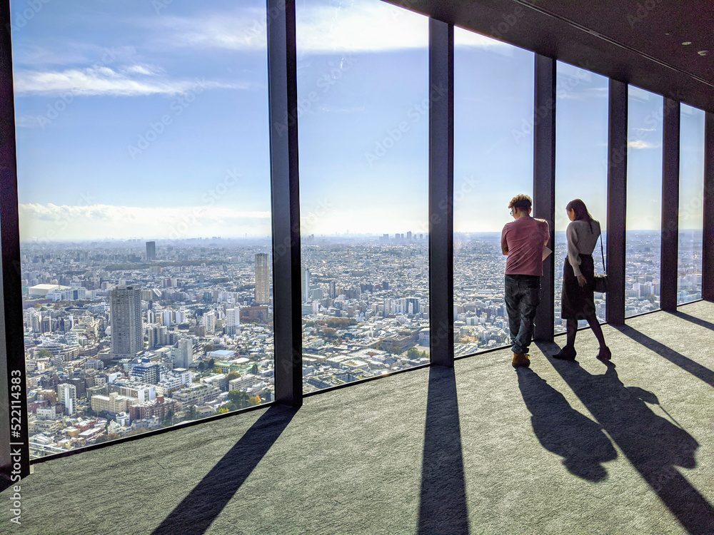 dating couple enjoing the view from a skyscraper