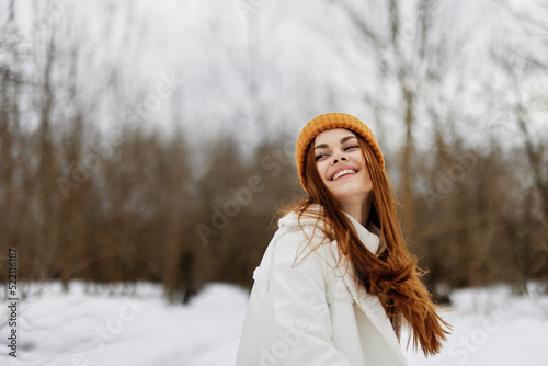 Happy young woman red hair walk in the fresh winter air