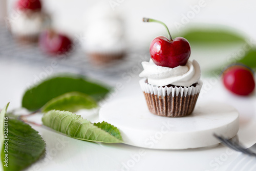 Chocolate Cherry cupcake white green leafes red. High quality photo