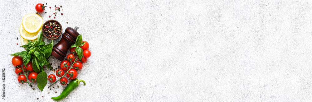 Pepper grinder, basil, cherry tomatoes on a white background with space for text. Food ingredients. Pepper grinder, basil, cherry tomatoes on a white background with space for text. Food ingredients.