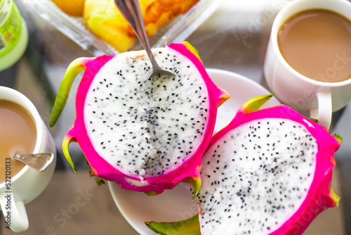 Morning breakfast on the table. Dragon fruit and coffee, top view