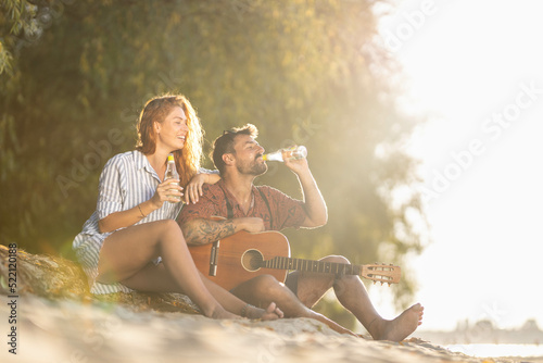 couple sitting on the beach in summer time © Nemanja