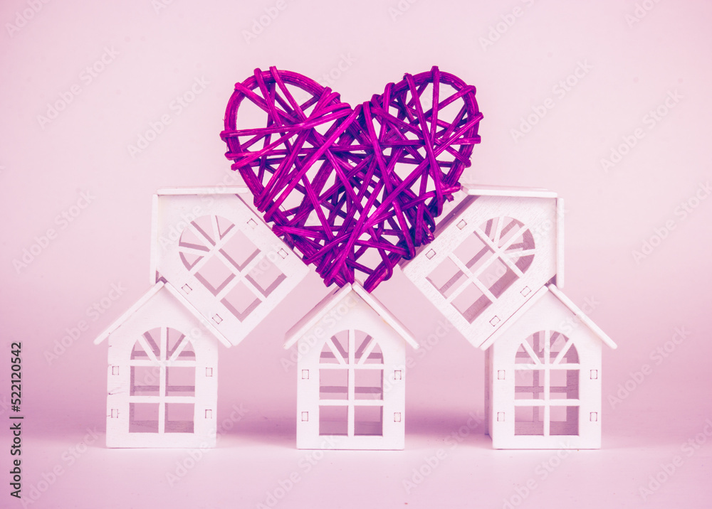 Home and love, family and support. Abstraction. White house and heart