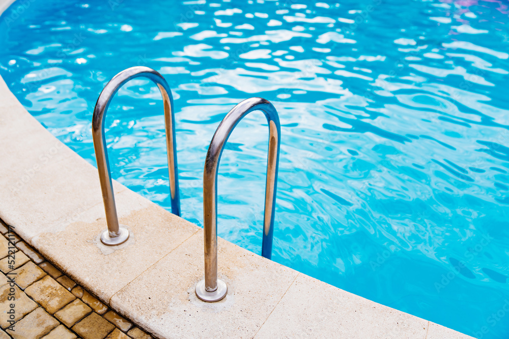 handrails of stairs for descent into the pool. the concept of summer holidays.