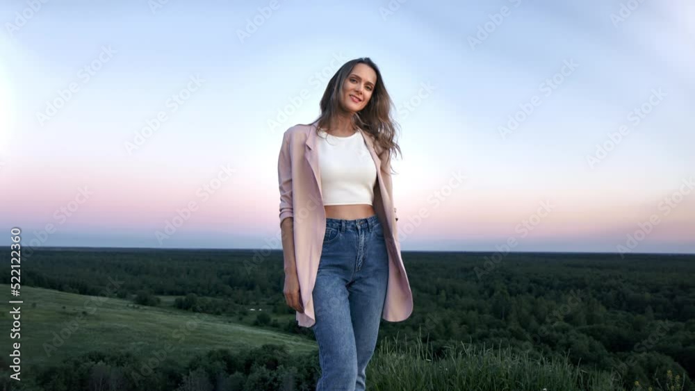 Smiling blonde fashion woman tourist posing sunrise sunset sky horizon landscape slow motion Smiling blonde fashion woman tourist posing sunrise sunset sky horizon landscape slow motion